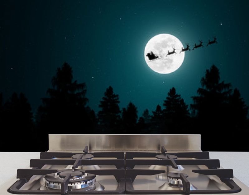 Santa Claus flying in his sleigh over the moon