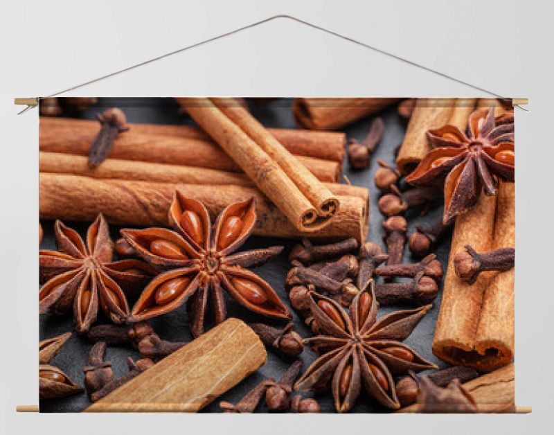 Lots of three spices for mulled wine – star anise, cinnamon and clove, macro.