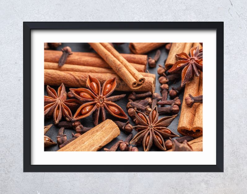 Lots of three spices for mulled wine – star anise, cinnamon and clove, macro.