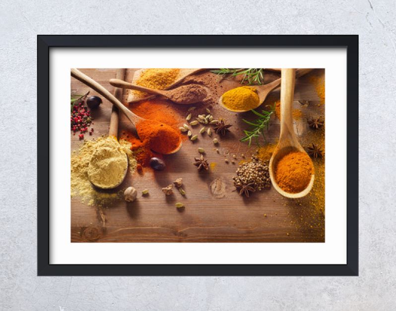 Various spices on wooden board.