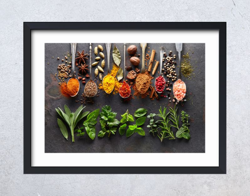 Spices and herbs on black board
