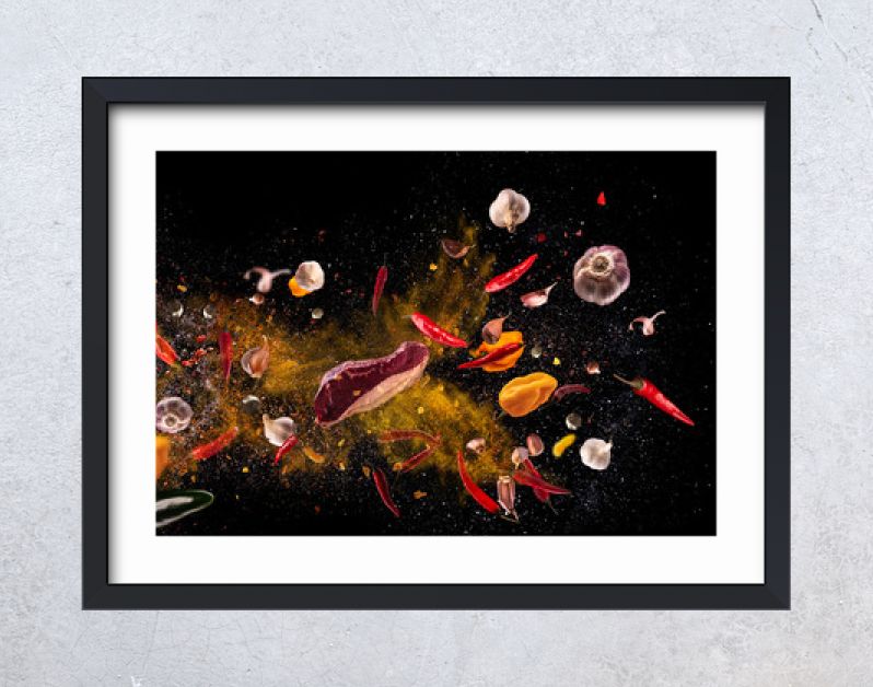 Hot red pepper, garlic, different spices powder meat stakes flying on a black background Motion freeze photo composition